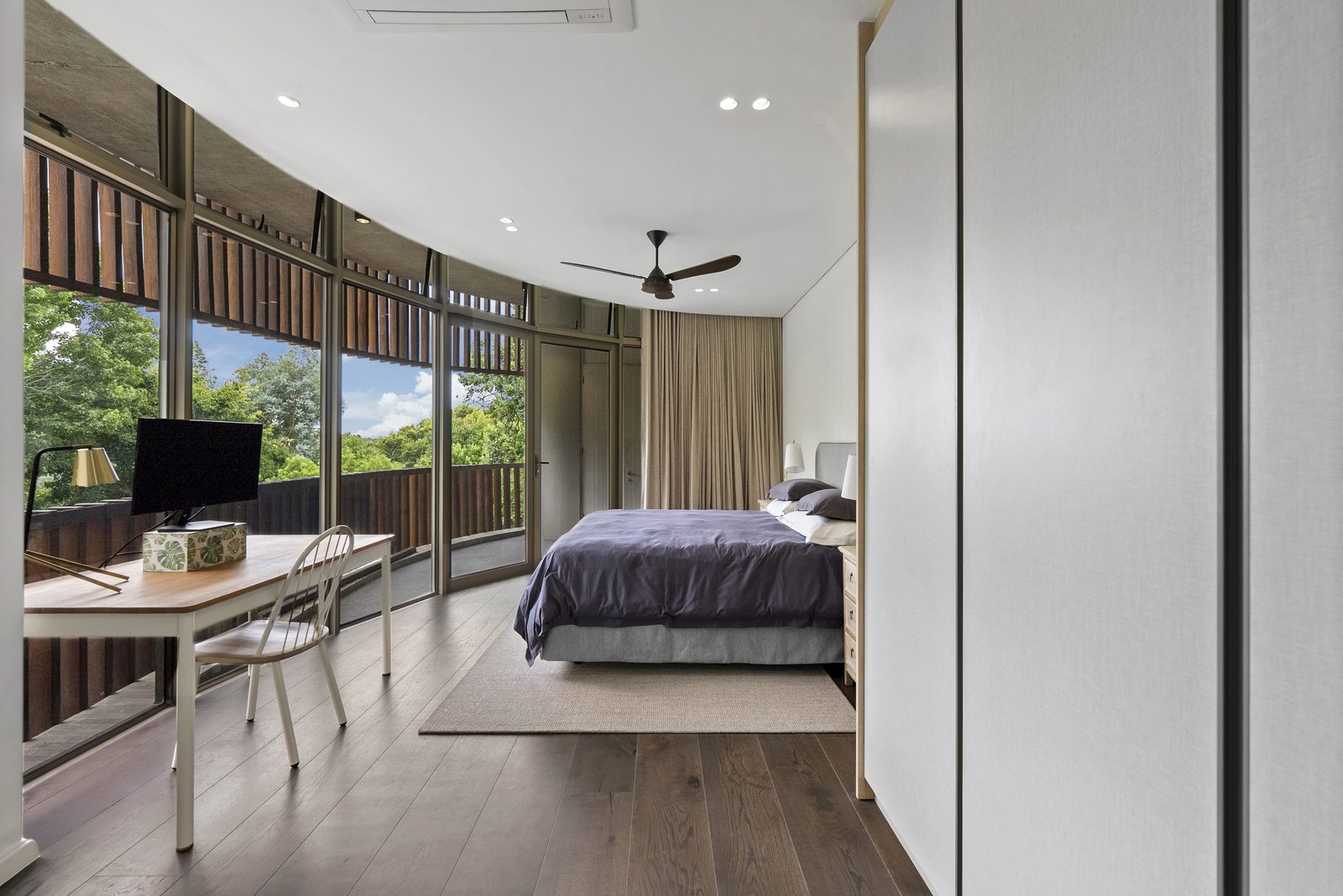 Bedroom two, with a desk under the curved glass