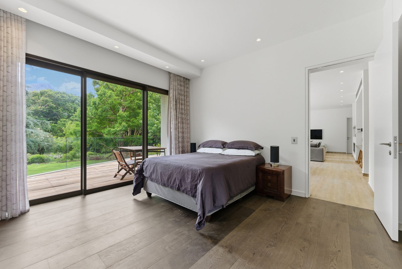 A Cottage bedroom opening onto the deck and the lawn